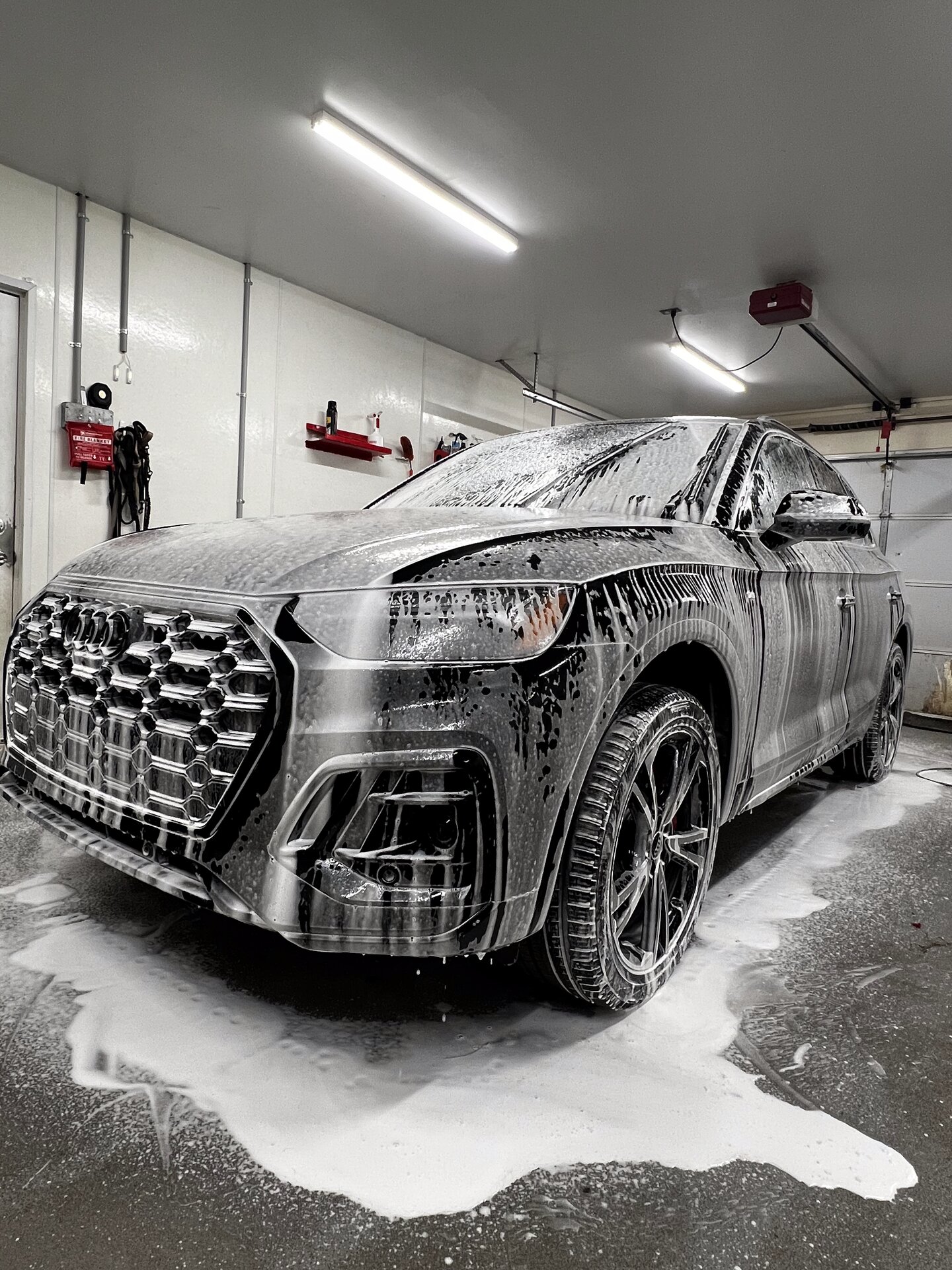 Audi Q8 covered in snow foam during professional exterior detailing