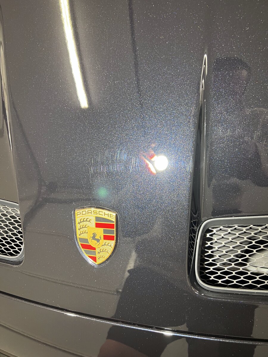 Porsche hood showing swirl marks before Stage 1 paint correction